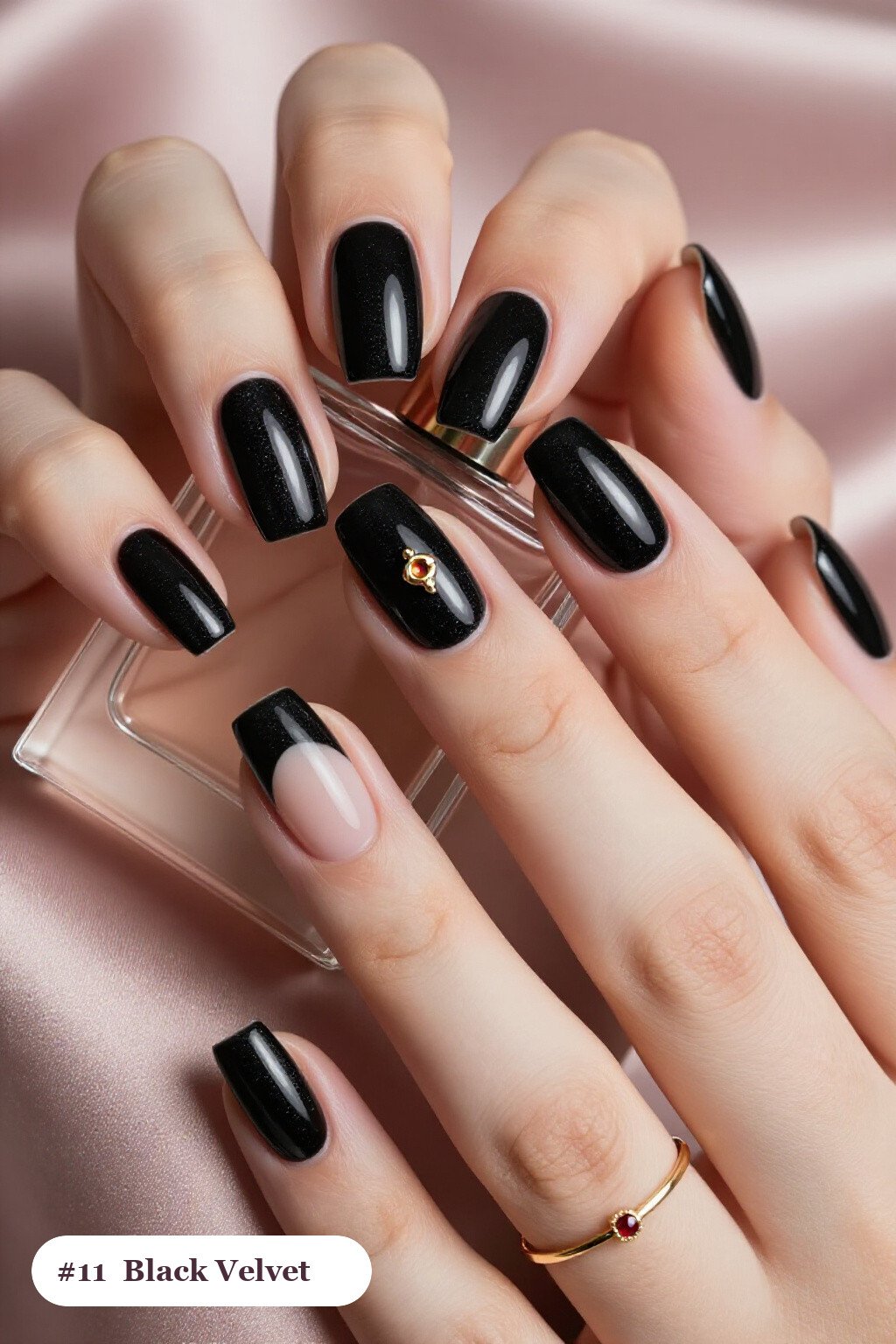 Short almond black nails in a velvet shimmer finish with one glossy accent nail with a gold charm, with soft nude details, perfect for halloween - short halloween nails black Short almond black nails in a velvet shimmer finish with one glossy accent nail with a gold charm, with soft nude details, perfect for halloween - short halloween nails black