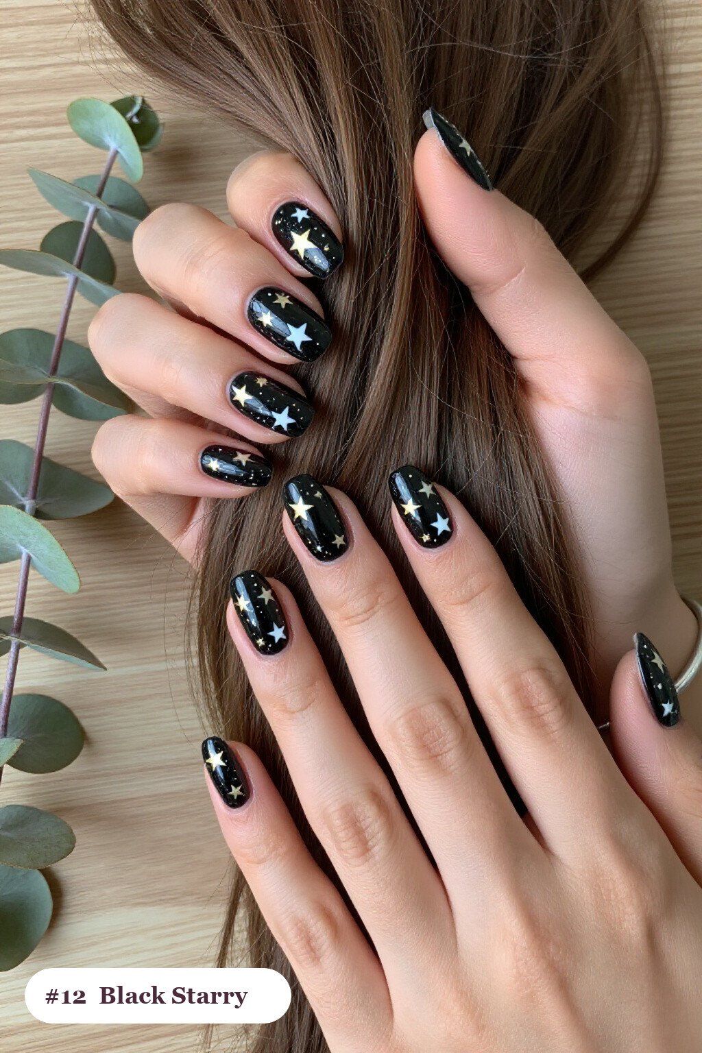 Short almond black nails with white and gold stars and sparkles painted on every nail, with gold details, perfect for halloween - short halloween nails black Short almond black nails with white and gold stars and sparkles painted on every nail, with gold details, perfect for halloween - short halloween nails black