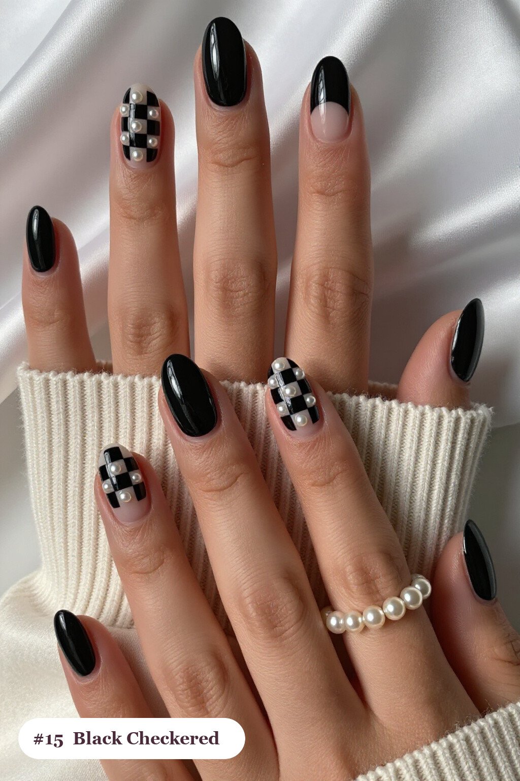 Short almond black nails with a bold checkerboard pattern on two accent nails and solid colour on the rest, with pearl details, perfect for halloween - short halloween nails black Short almond black nails with a bold checkerboard pattern on two accent nails and solid colour on the rest, with pearl details, perfect for halloween - short halloween nails black