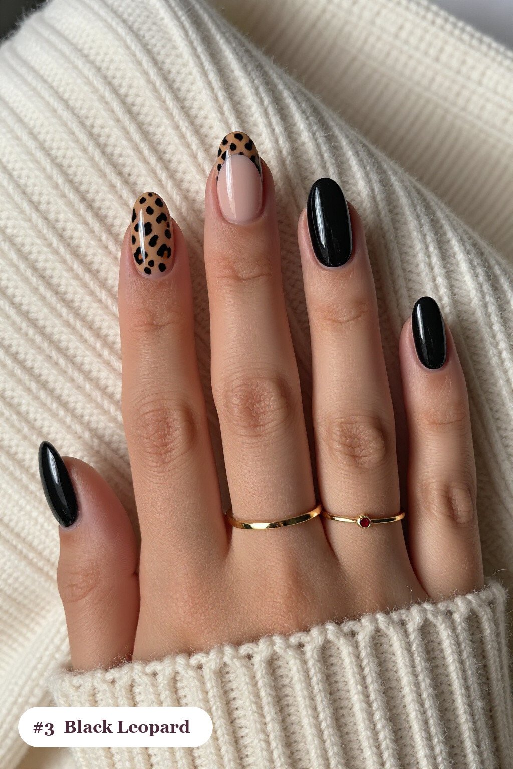 Short almond black nails with a leopard print pattern on two accent nails and solid colour on the rest, with soft nude details, perfect for halloween - short halloween nails black Short almond black nails with a leopard print pattern on two accent nails and solid colour on the rest, with soft nude details, perfect for halloween - short halloween nails black