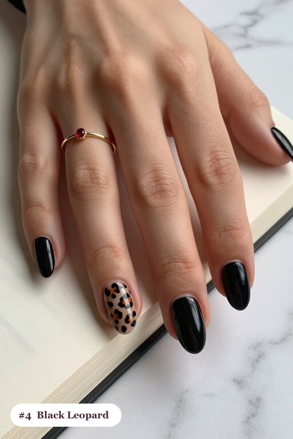 Short almond black nails with a leopard print pattern on two accent nails and solid colour on the rest, perfect for halloween - short simple halloween nail ideas Short almond black nails with a leopard print pattern on two accent nails and solid colour on the rest, perfect for halloween - short simple halloween nail ideas