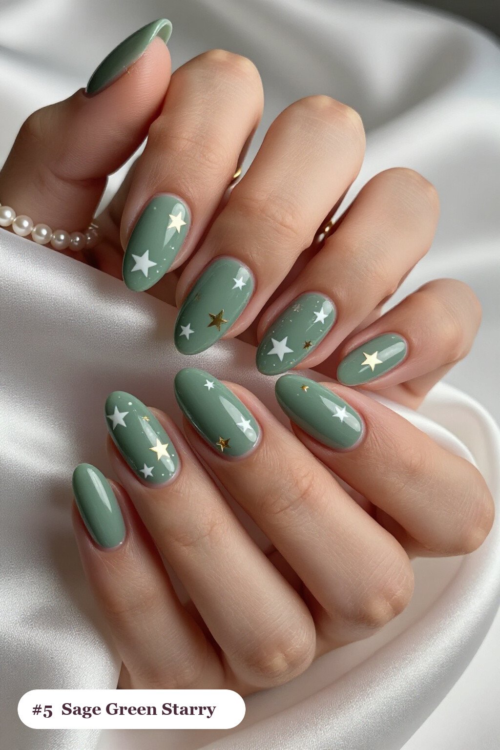 Sage Green Almond Nails Covered in White and Gold Stars and Sparkles - simple almond nails designs