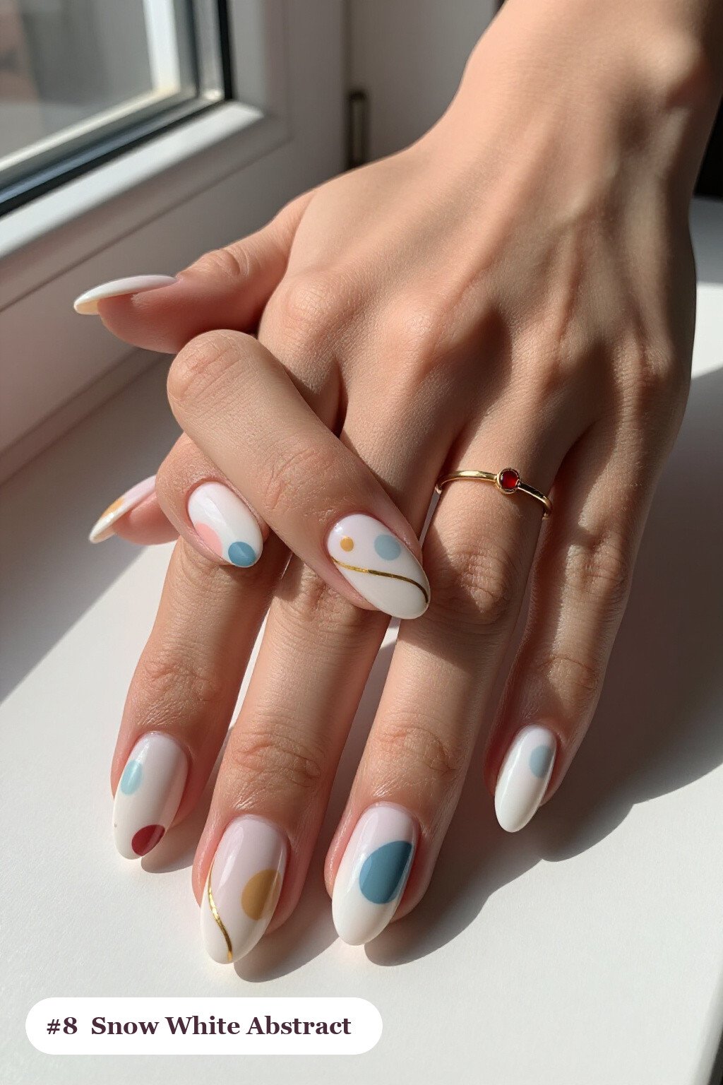 Medium almond snow white nails with abstract art of colour blobs, gold outlines and dots, perfect for christmas - simple christmas nails Medium almond snow white nails with abstract art of colour blobs, gold outlines and dots, perfect for christmas - simple christmas nails