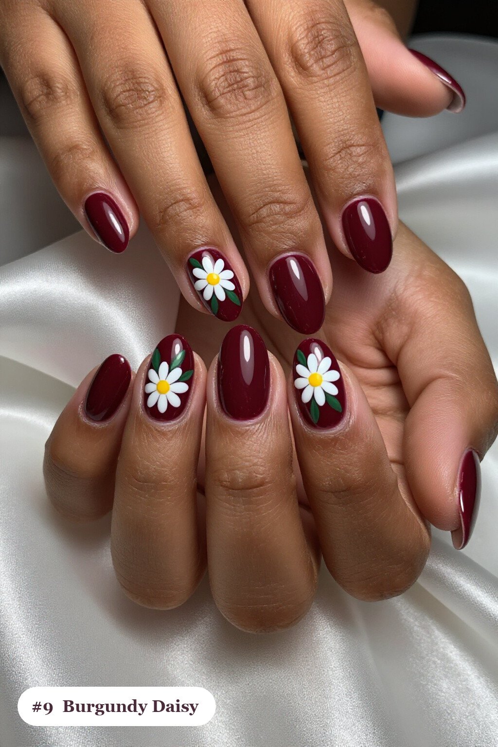 Medium oval burgundy nails with hand-painted daisies and green leaves across every nail, perfect for christmas - simple christmas nails Medium oval burgundy nails with hand-painted daisies and green leaves across every nail, perfect for christmas - simple christmas nails