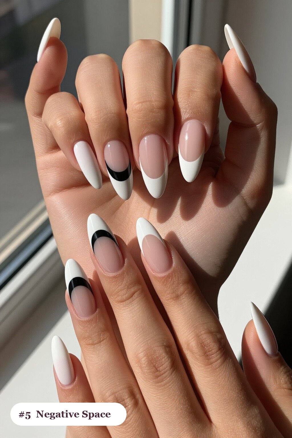 Long almond bone white nails in a negative-space design with sheer nude windows and bold colour shapes, perfect for halloween - simple halloween nail designs