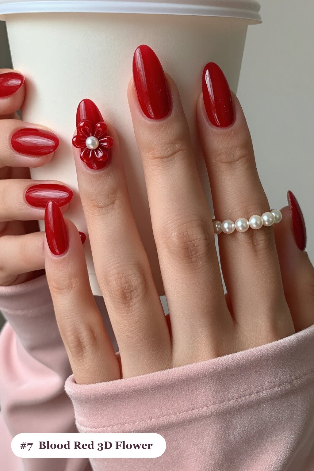 Medium almond blood red nails with raised 3D flowers with pearl centres on two accent nails, perfect for halloween - simple halloween nail designs