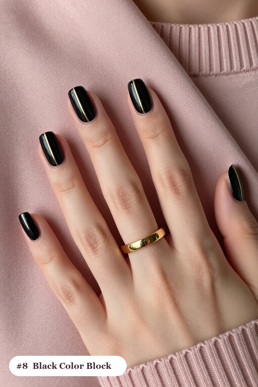Medium coffin black nails in a colour-block design split diagonally with a thin gold line, perfect for halloween - simple halloween nail designs