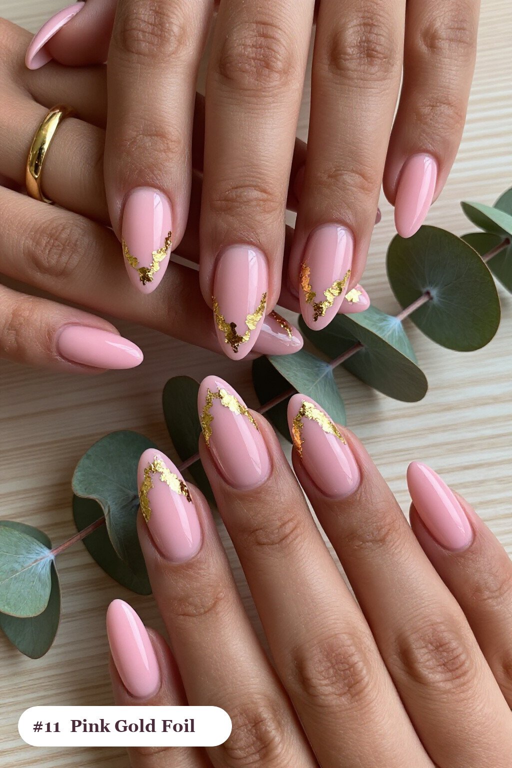 Long coffin pink nails with dense gold foil flakes and gold leaf scattered across every nail, with soft nude details - simple pink nails