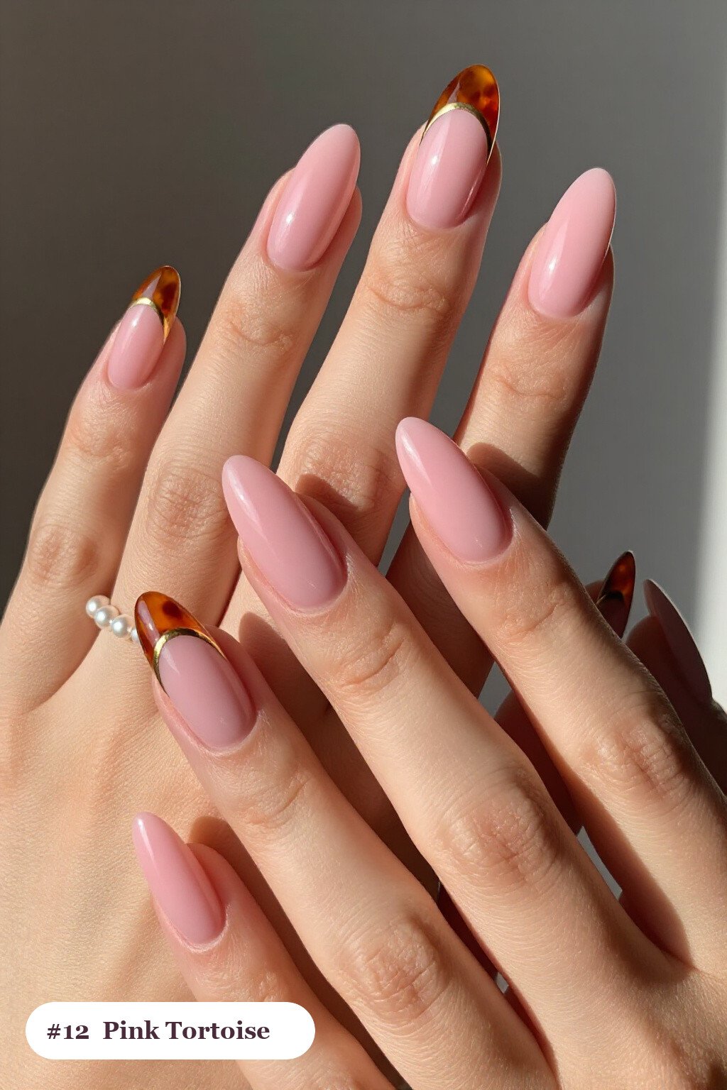 Long ballerina pink nails with glossy amber tortoiseshell on two accent nails, with gold details - simple pink nails
