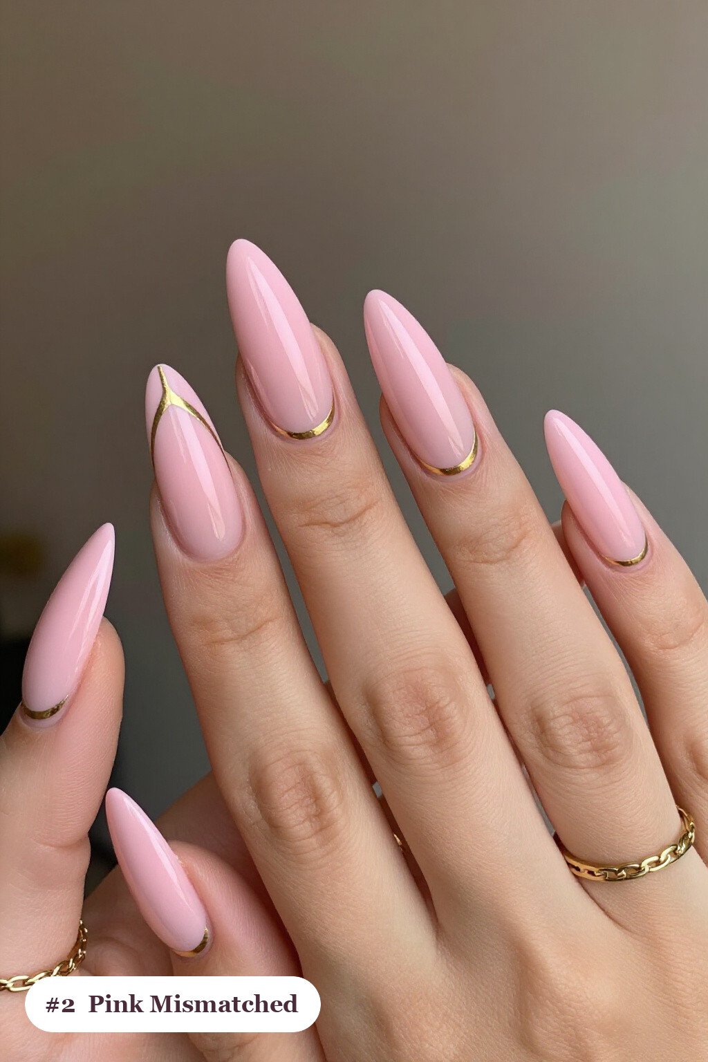 Long ballerina pink nails as a mismatched set where every nail has a different pattern in the same colour story, with gold details - simple pink nails