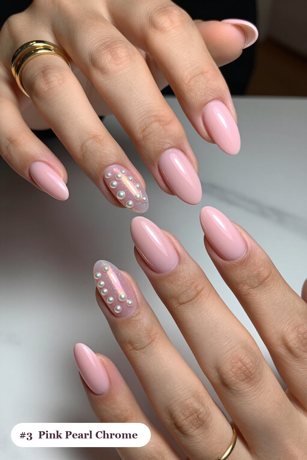 Long almond pink nails with glazed pearl chrome over the colour for an iridescent sheen, with soft nude details - simple pink nails