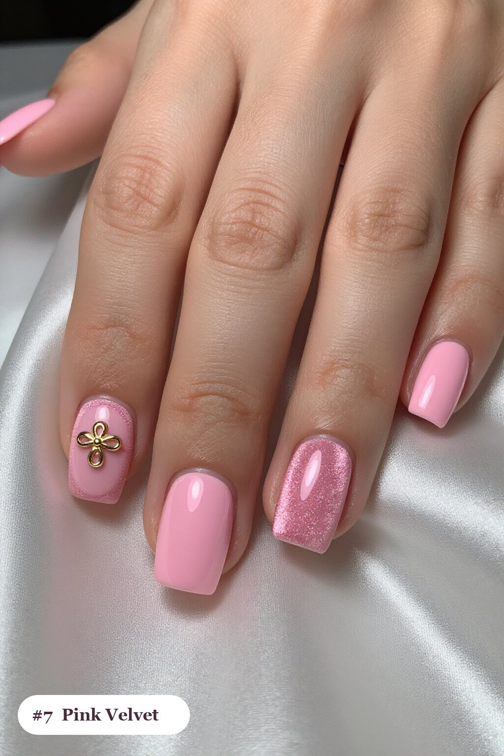 Short square pink nails in a velvet shimmer finish with one glossy accent nail with a gold charm, with rose gold details - simple pink nails