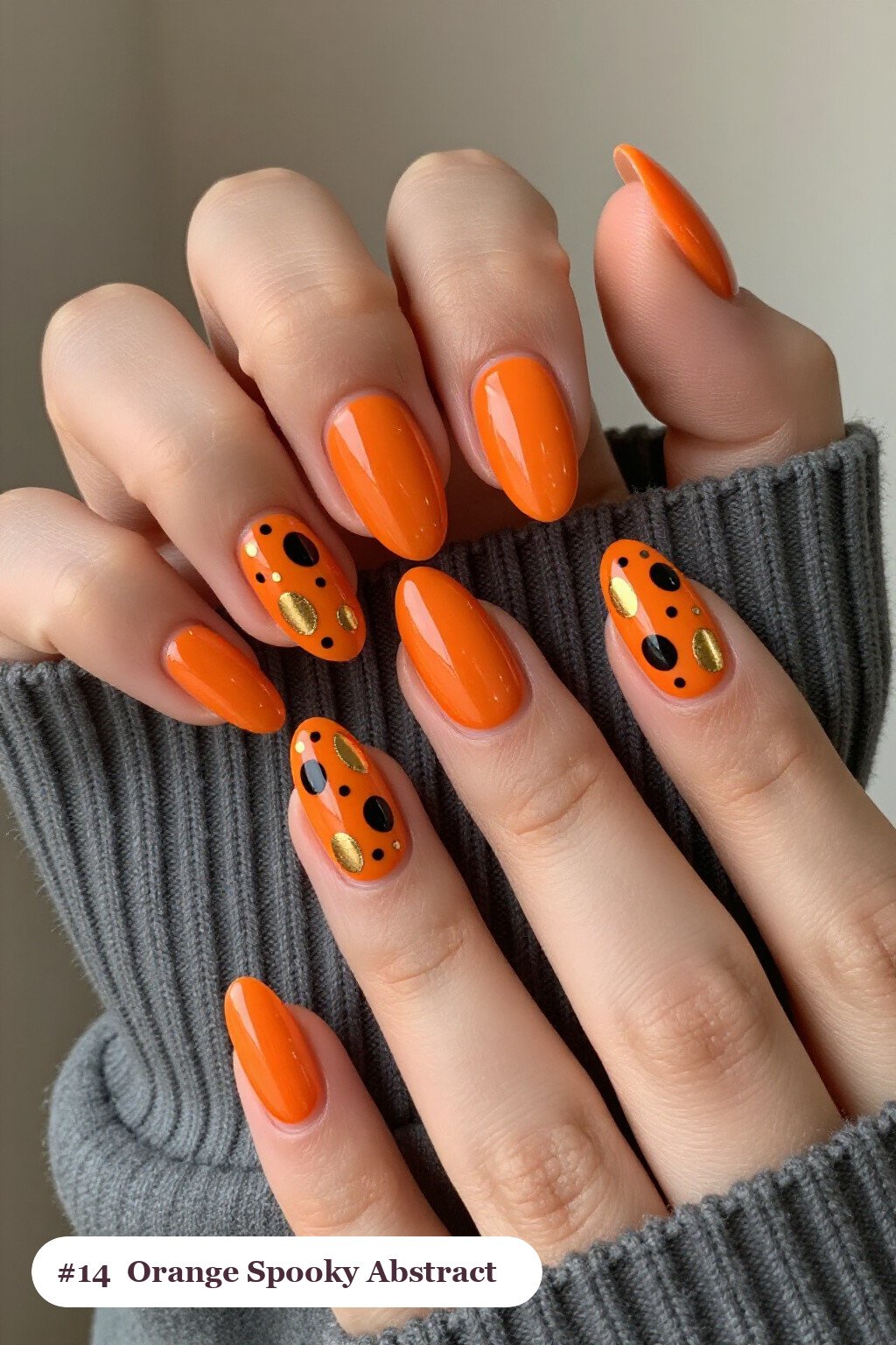 Medium almond orange spooky nails with abstract art of colour blobs, gold outlines and dots, perfect for halloween - spooky halloween nails almond