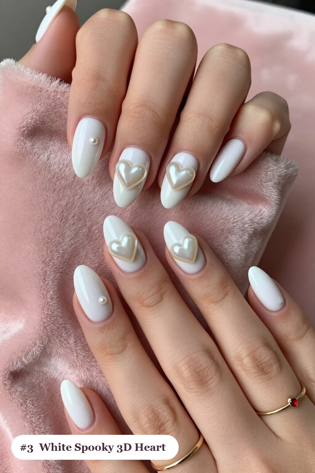 Medium almond bone white spooky nails with chunky 3D gel hearts and pearls on three nails, perfect for halloween - spooky halloween nails almond