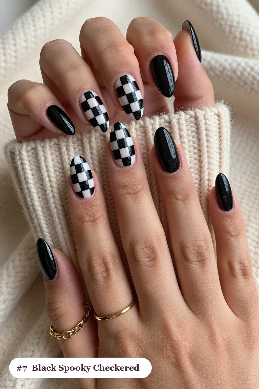 Medium almond black spooky nails with a bold checkerboard pattern on two accent nails and solid colour on the rest, perfect for halloween - spooky halloween nails almond