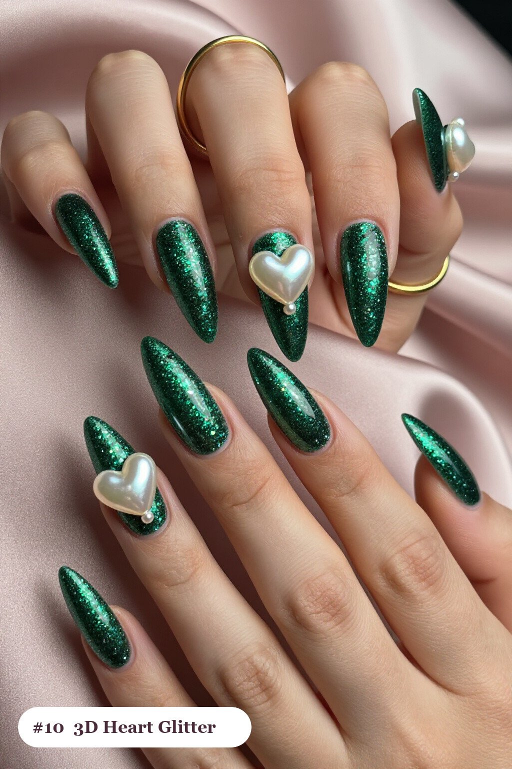 Long stiletto emerald glitter nails with sparkling glitter clearly visible on every nail, styled with chunky 3D gel hearts and pearls on three nails, perfect for winter - winter glitter nails