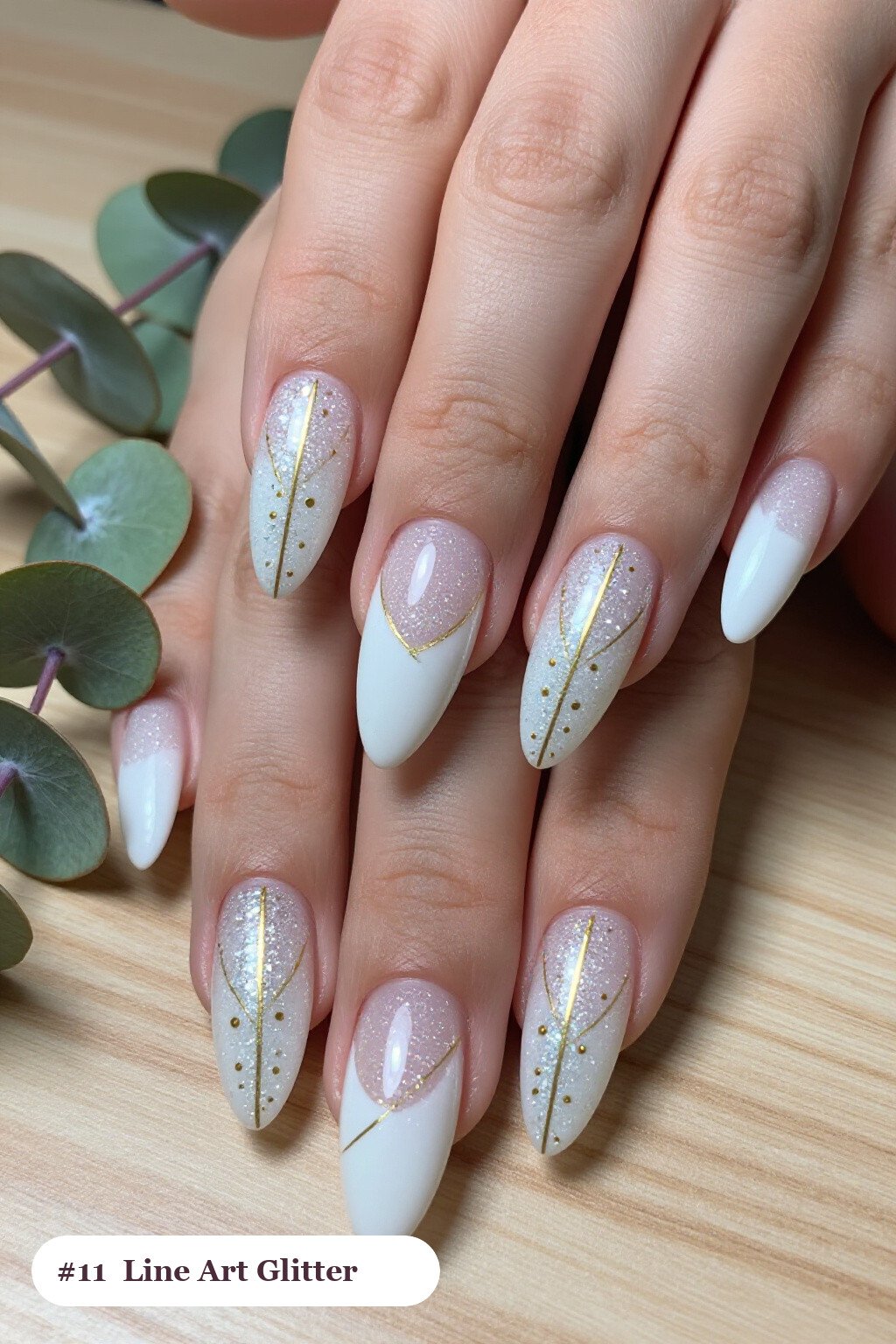 Long coffin snow white glitter nails with sparkling glitter clearly visible on every nail, styled with fine gold line art and tiny dots drawn across every nail, perfect for winter - winter glitter nails