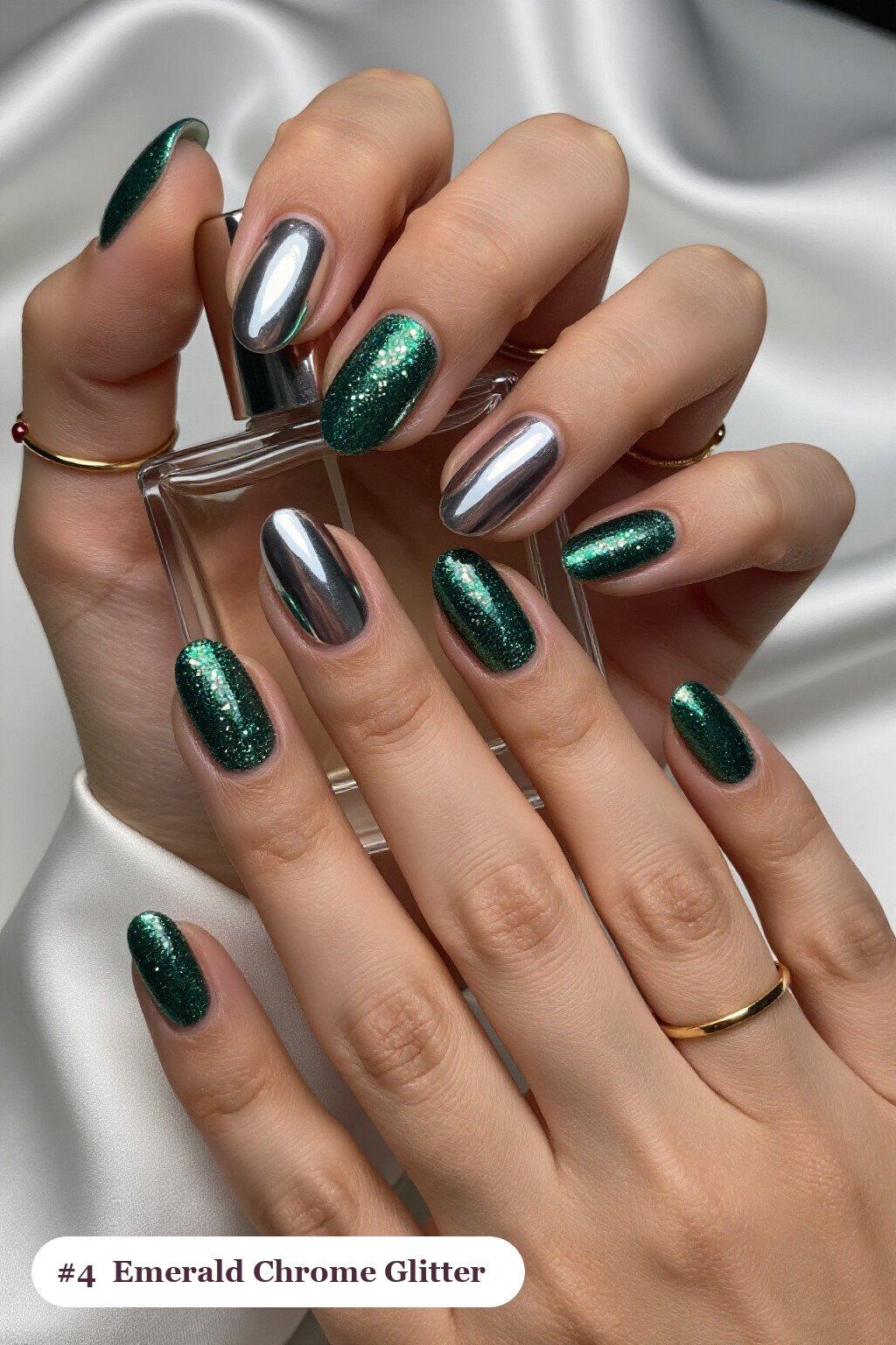 Medium oval emerald glitter nails with sparkling glitter clearly visible on every nail, styled with a liquid chrome mirror finish and bright metallic highlights, perfect for winter - winter glitter nails