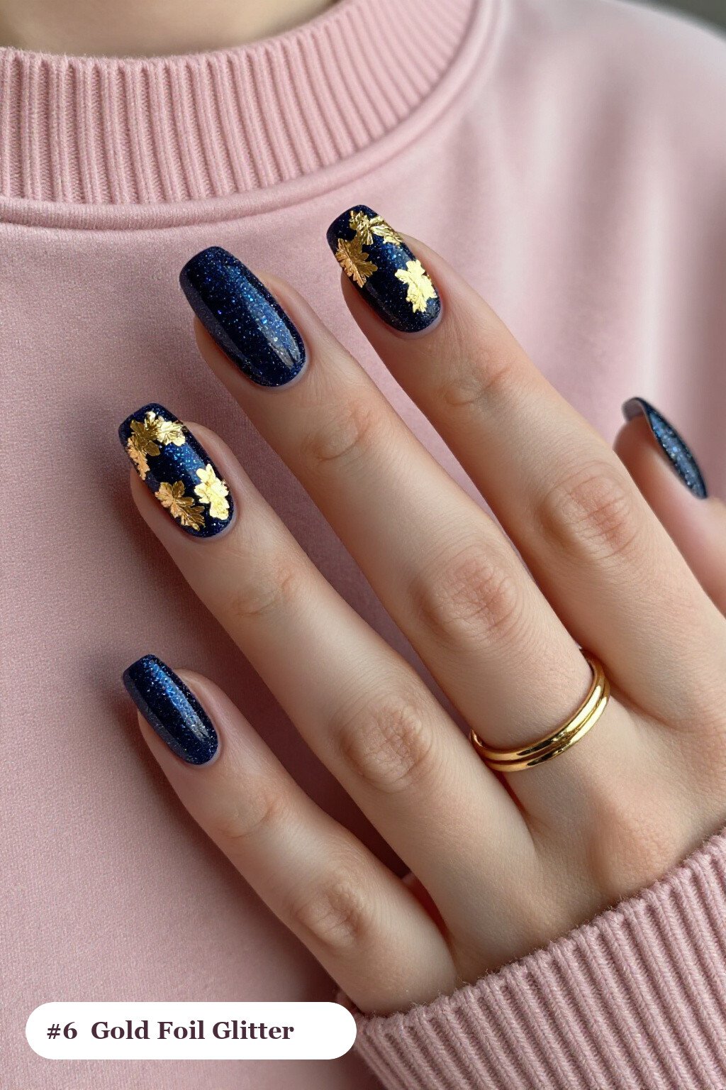 Medium coffin deep navy glitter nails with sparkling glitter clearly visible on every nail, styled with dense gold foil flakes and gold leaf scattered across every nail, perfect for winter - winter glitter nails