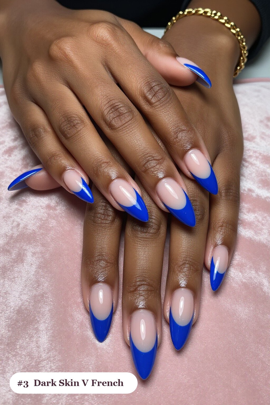 Long stiletto icy blue dark skin nails with deep V-shaped french tips in a bold contrasting colour, perfect for winter - winter nails for dark skin