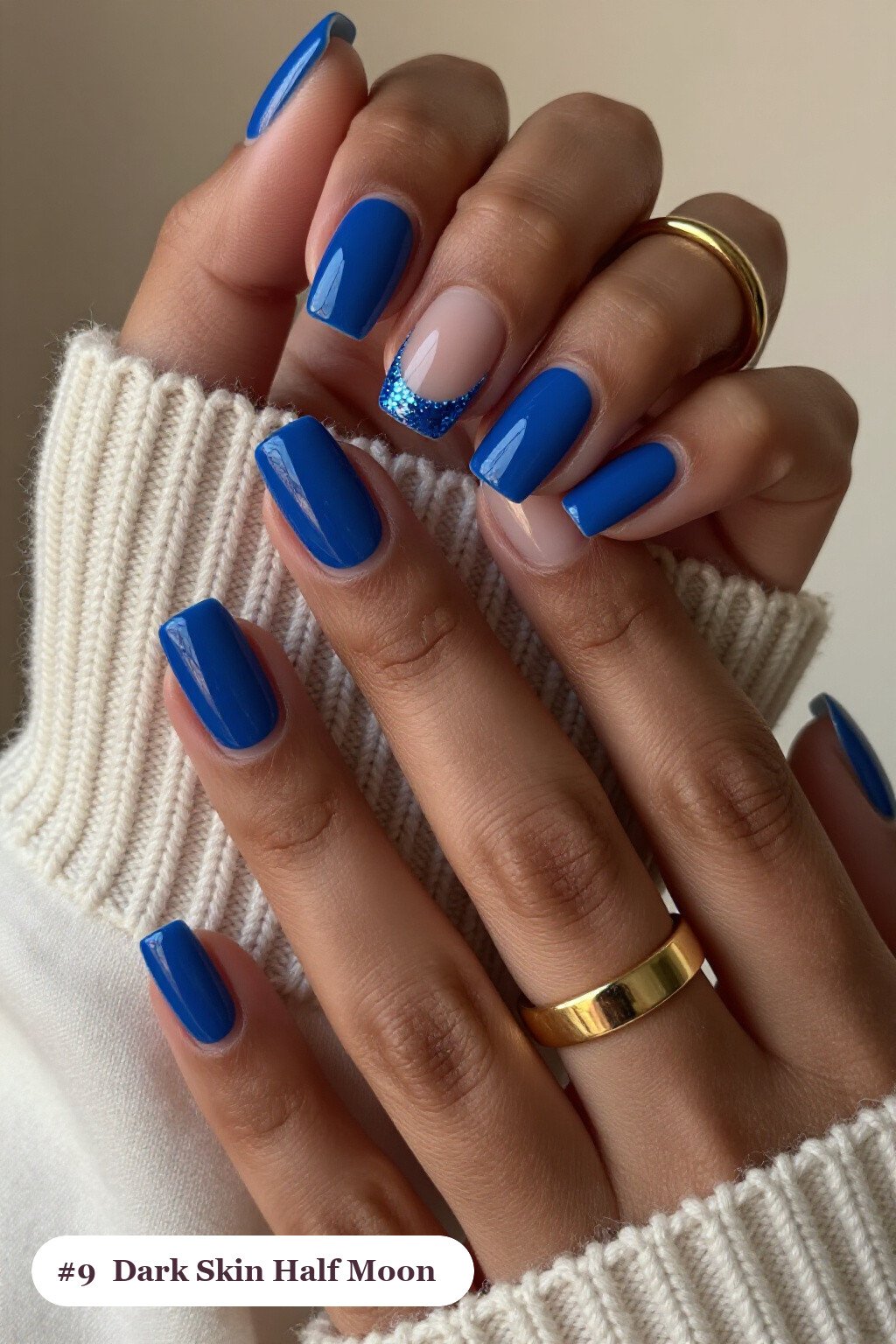 Short square icy blue dark skin nails in a half-moon design with a glitter crescent at the cuticle, perfect for winter - winter nails for dark skin
