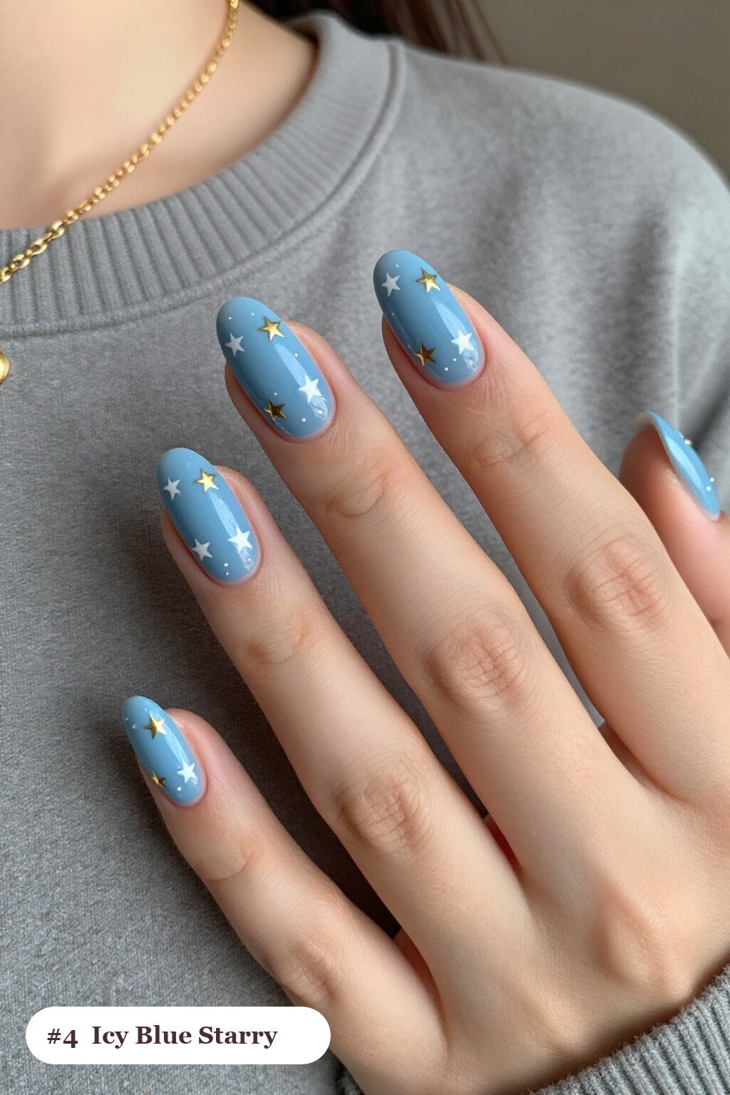 Icy Blue Short Almond Nails Sprinkled with White and Gold Stars - winter short nails Icy Blue Short Almond Nails Sprinkled with White and Gold Stars - winter short nails