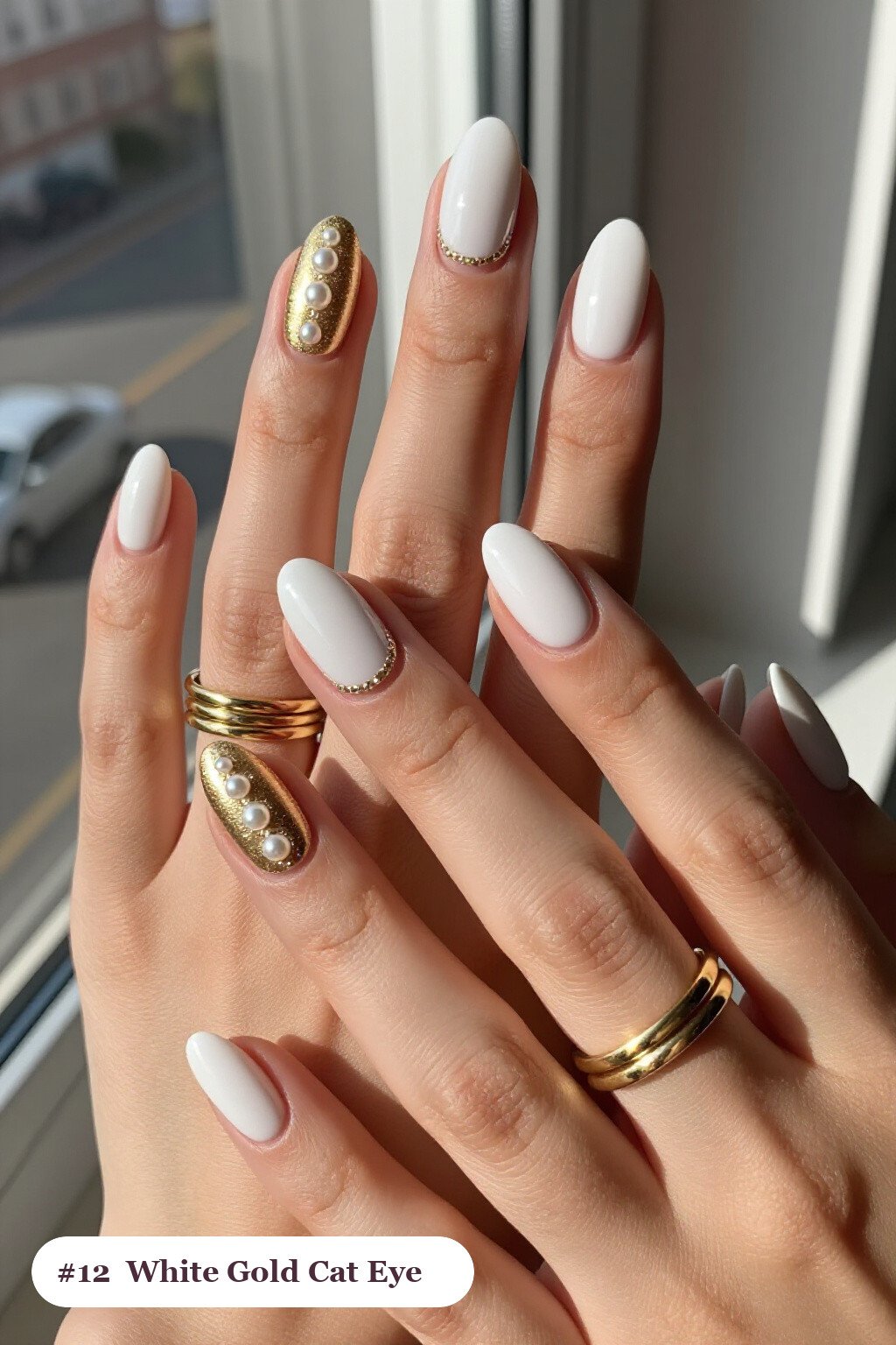 Medium oval white gold nails with a glowing shimmer band of light running down the centre of each nail like a gemstone, with pearl details, perfect for winter - winter white and gold nails