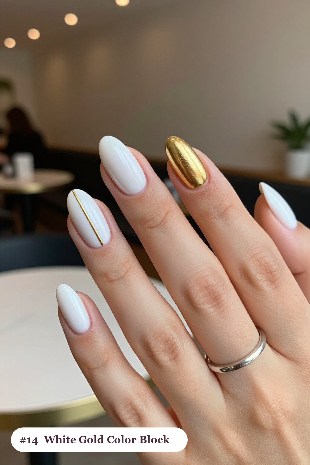 Medium coffin white gold nails in a colour-block design split diagonally with a thin gold line, perfect for winter - winter white and gold nails