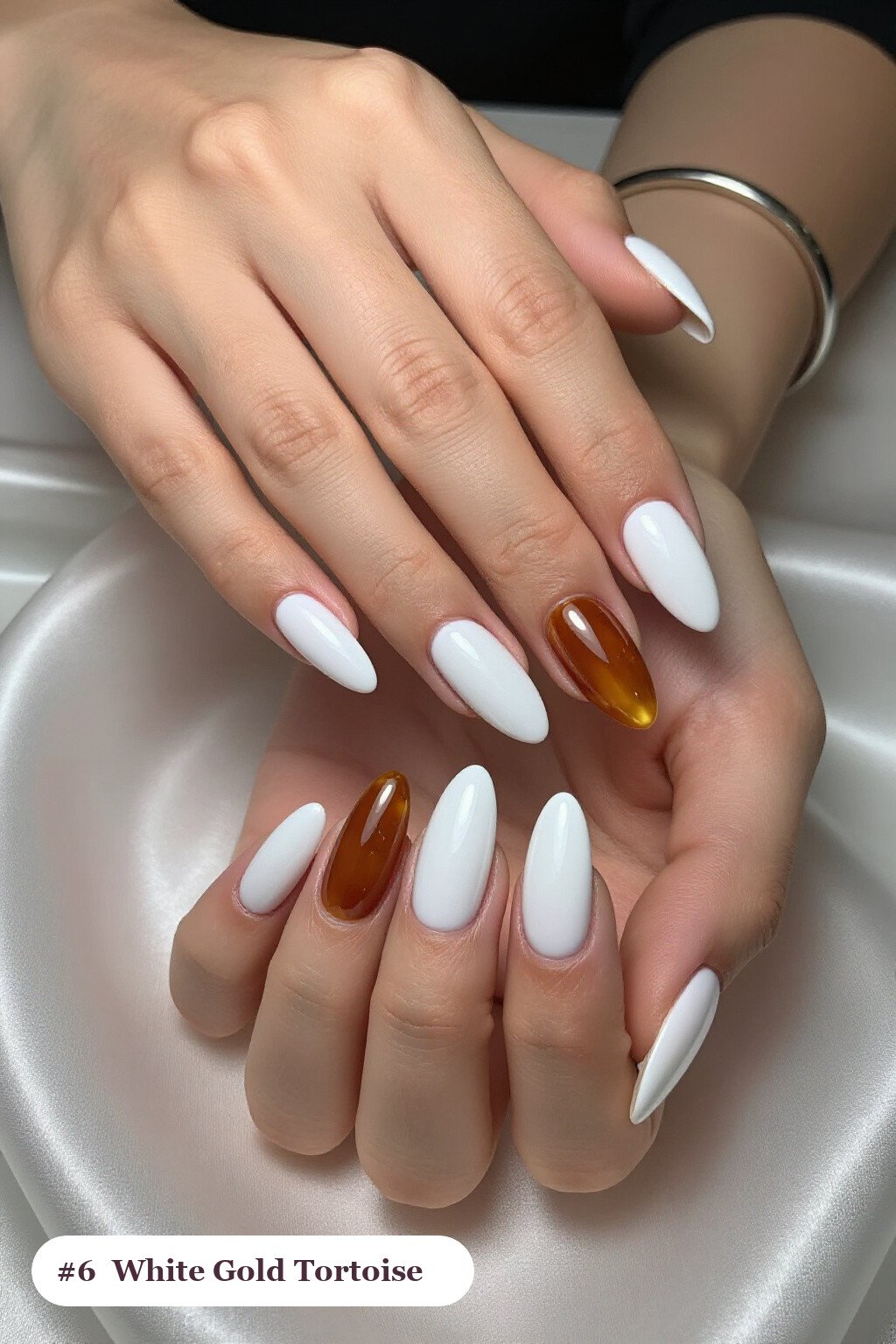 Long almond white gold nails with glossy amber tortoiseshell on two accent nails, perfect for winter - winter white and gold nails