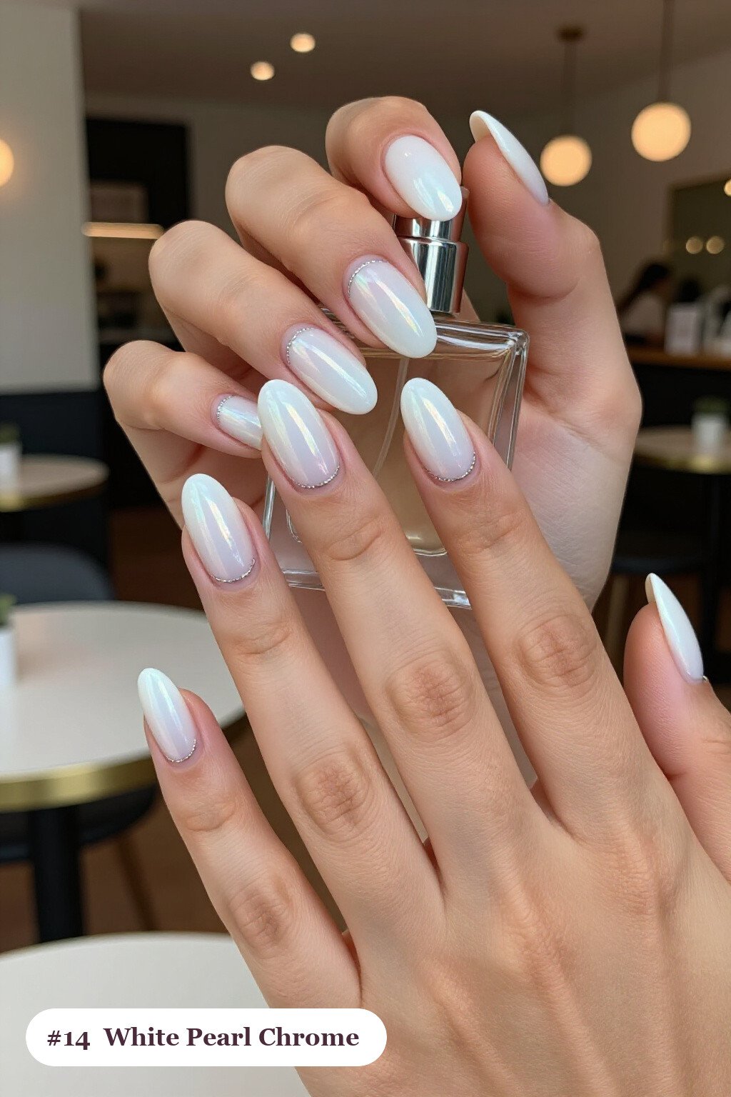 Medium coffin white nails with glazed pearl chrome over the colour for an iridescent sheen, with silver details, perfect for winter - winter white nails