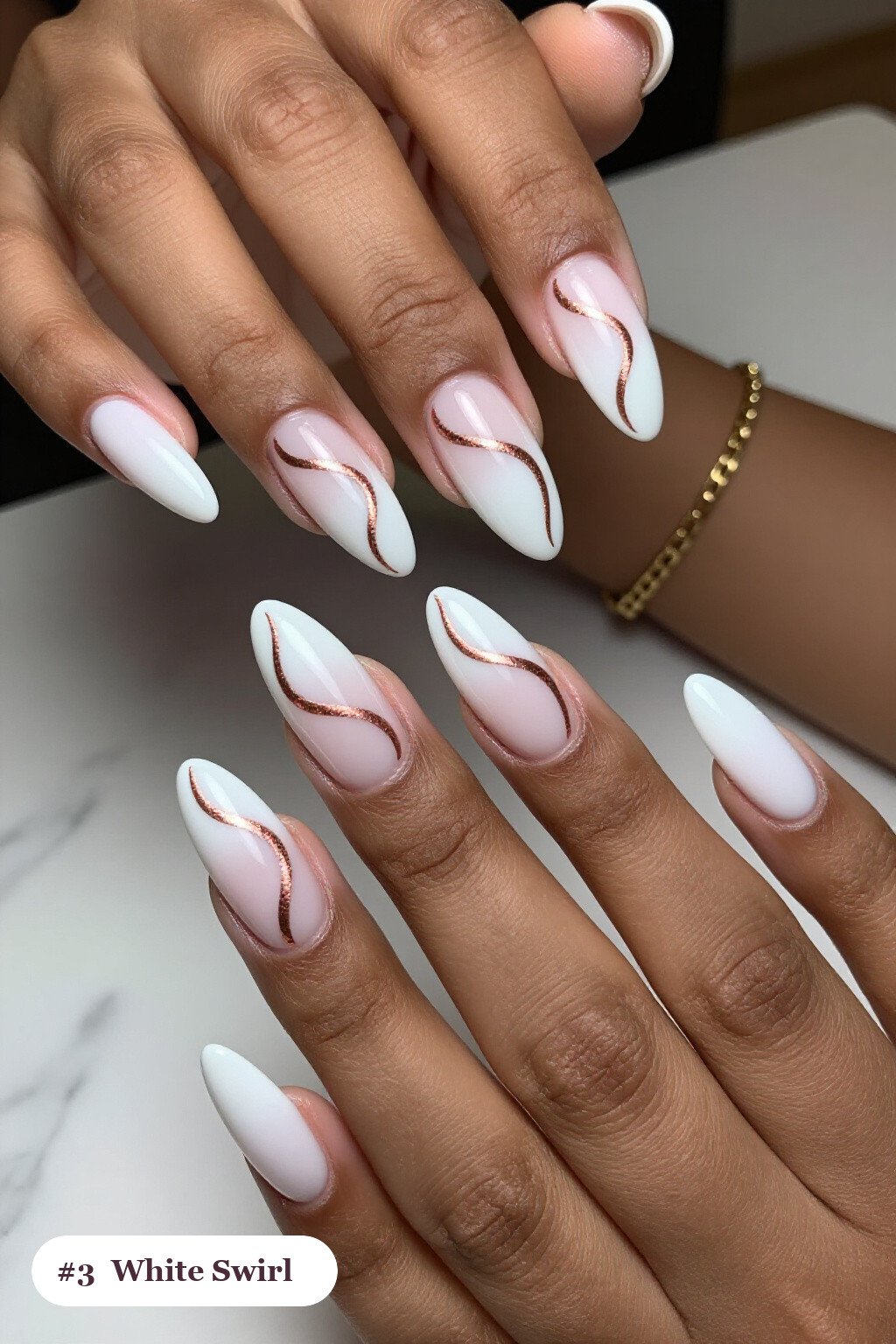 Long ballerina white nails with bold hand-painted swirl lines flowing across every nail in a contrasting colour, with rose gold details, perfect for winter - winter white nails