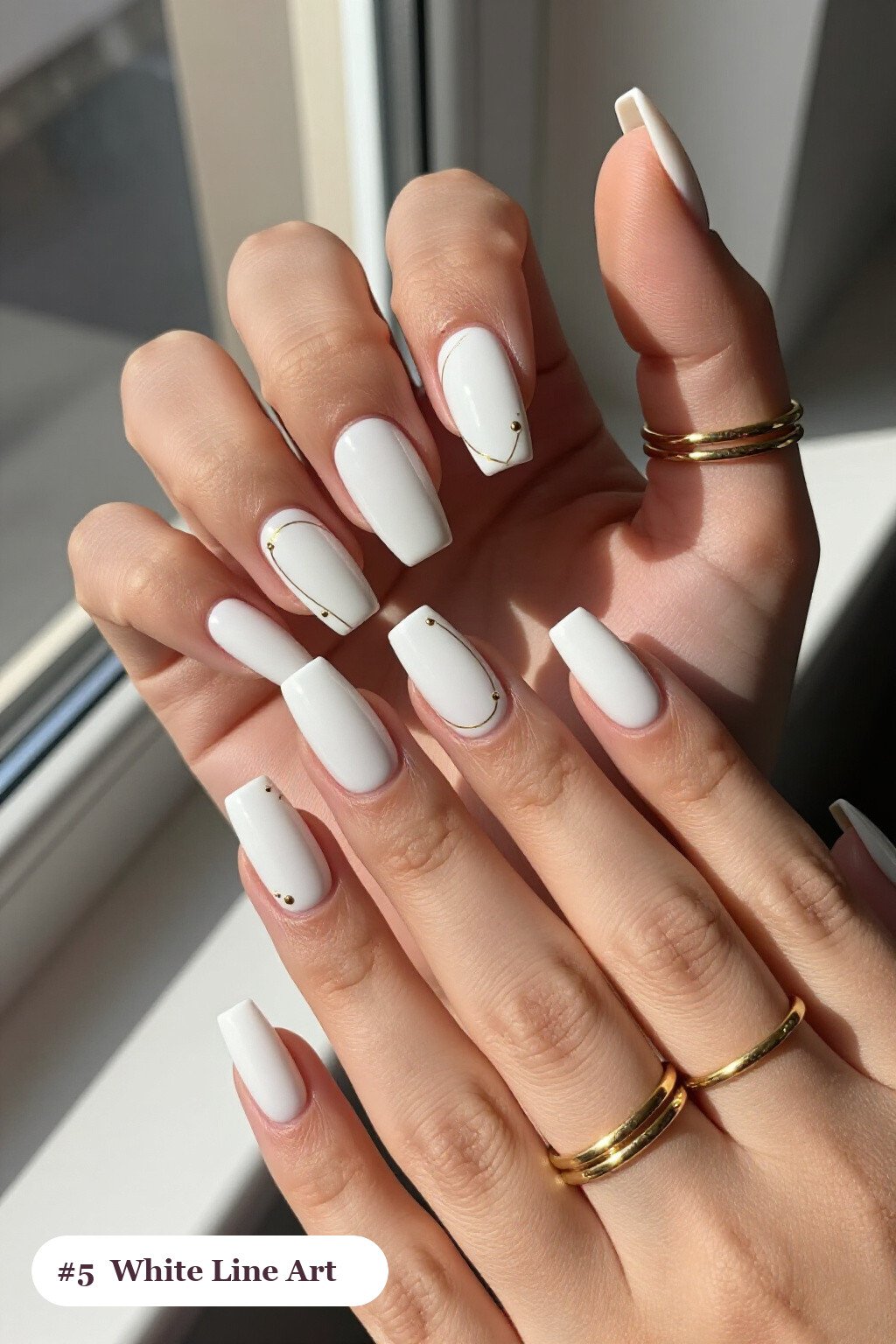 Long square white nails with fine gold line art and tiny dots drawn across every nail, with gold details, perfect for winter - winter white nails