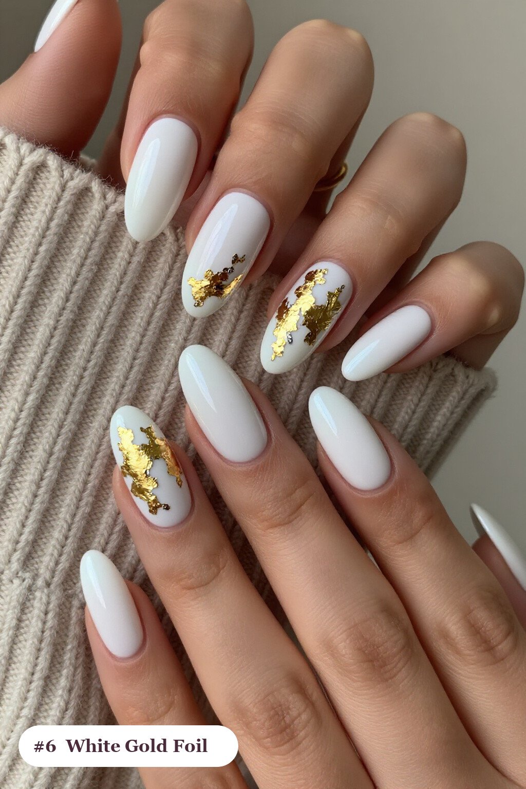 Long coffin white nails with dense gold foil flakes and gold leaf scattered across every nail, with silver details, perfect for winter - winter white nails