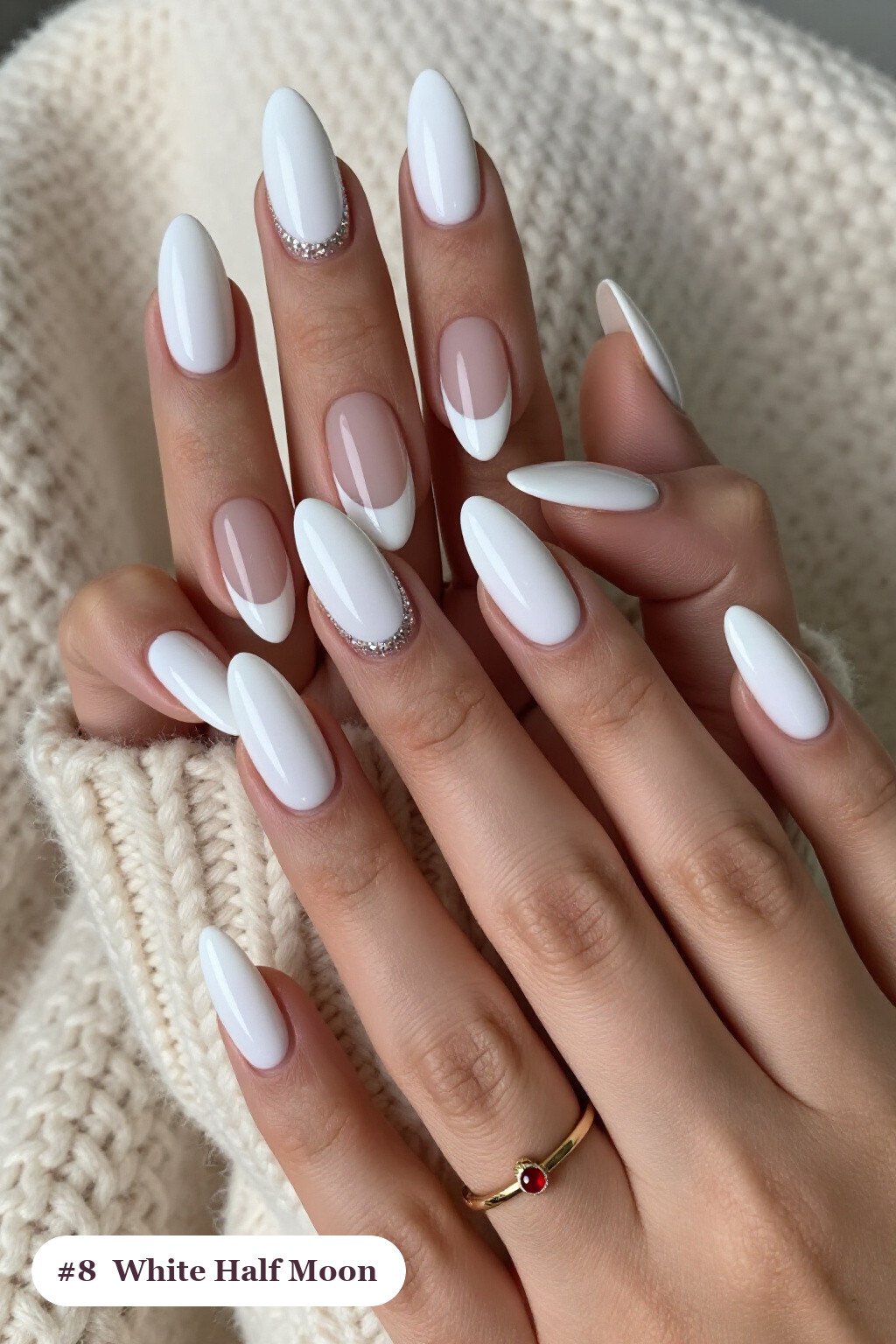 Long almond white nails in a half-moon design with a glitter crescent at the cuticle, with soft nude details, perfect for winter - winter white nails