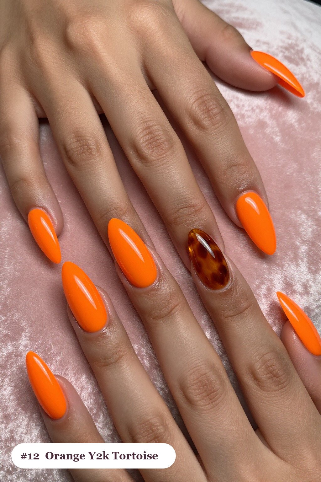 Long almond orange y2k nails with glossy amber tortoiseshell on two accent nails, perfect for halloween - y2k halloween nails