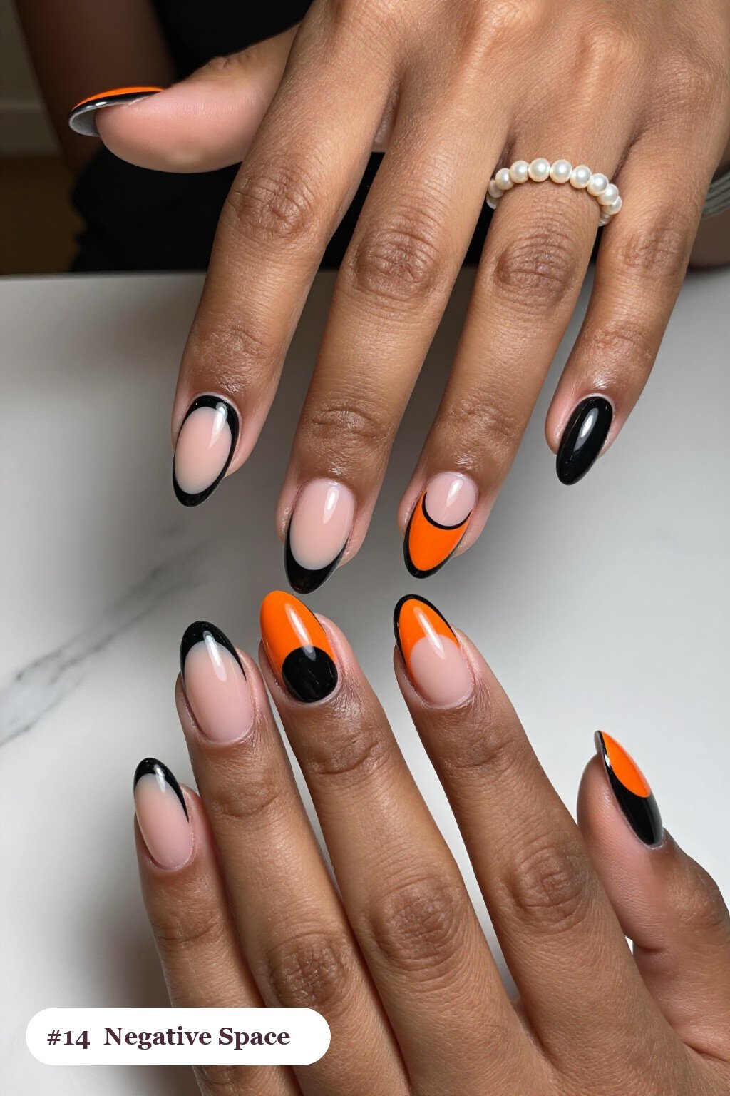 Medium oval black y2k nails in a negative-space design with sheer nude windows and bold colour shapes, perfect for halloween - y2k halloween nails