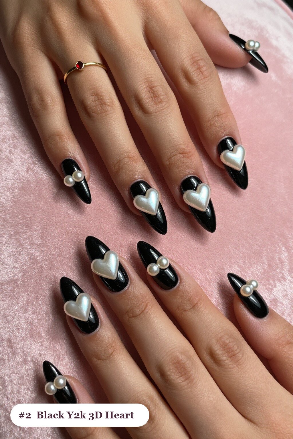 Long almond black y2k nails with chunky 3D gel hearts and pearls on three nails, perfect for halloween - y2k halloween nails